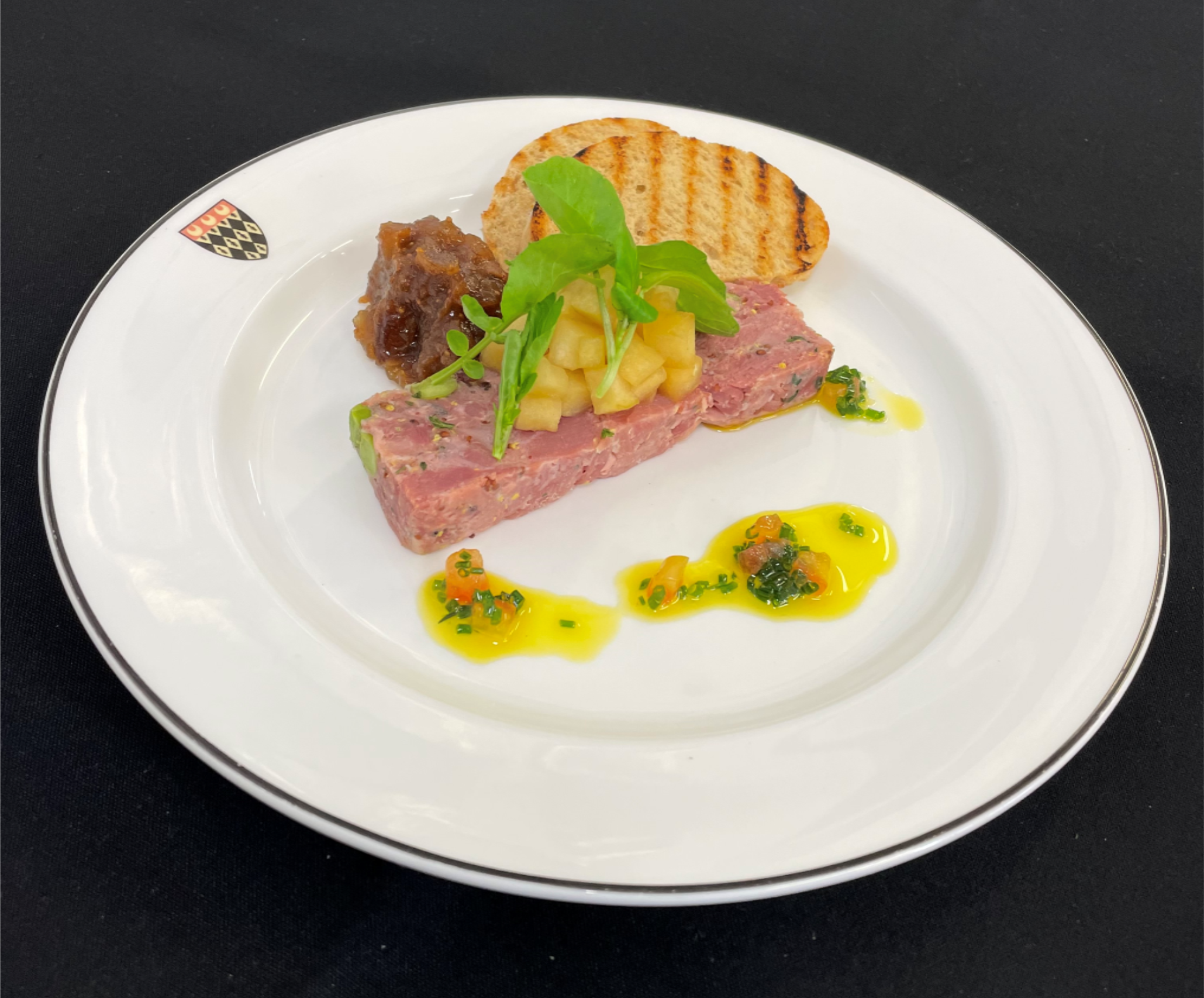 Pressed ham hock: with pea shoots served with a caramelised apple salad and sourdough croute