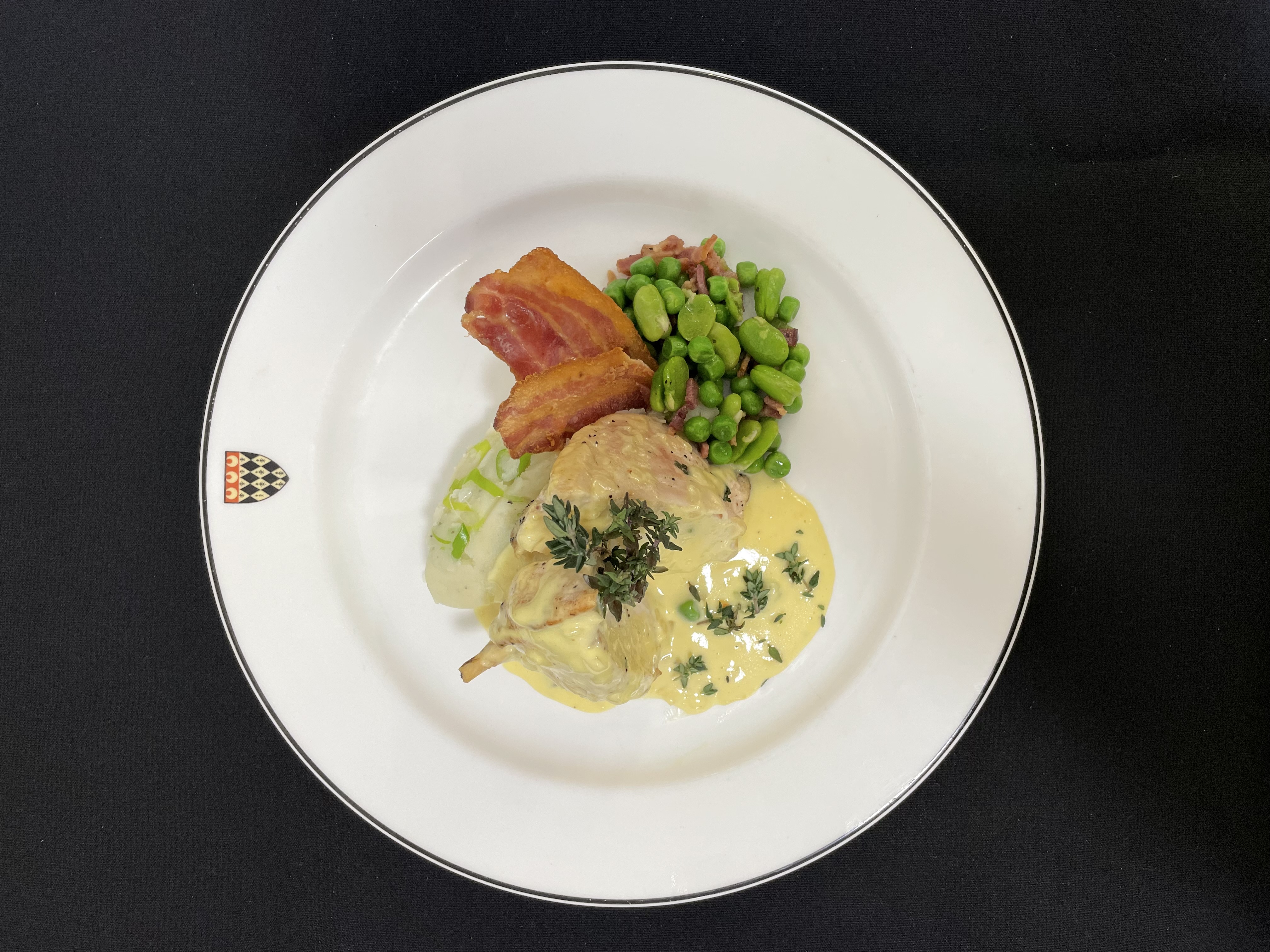 British chicken suprème: served with a leek and mushroom mousse, spring onion mash, peas, broad beans, Gloucester old spot bacon and beurre blanc sauce