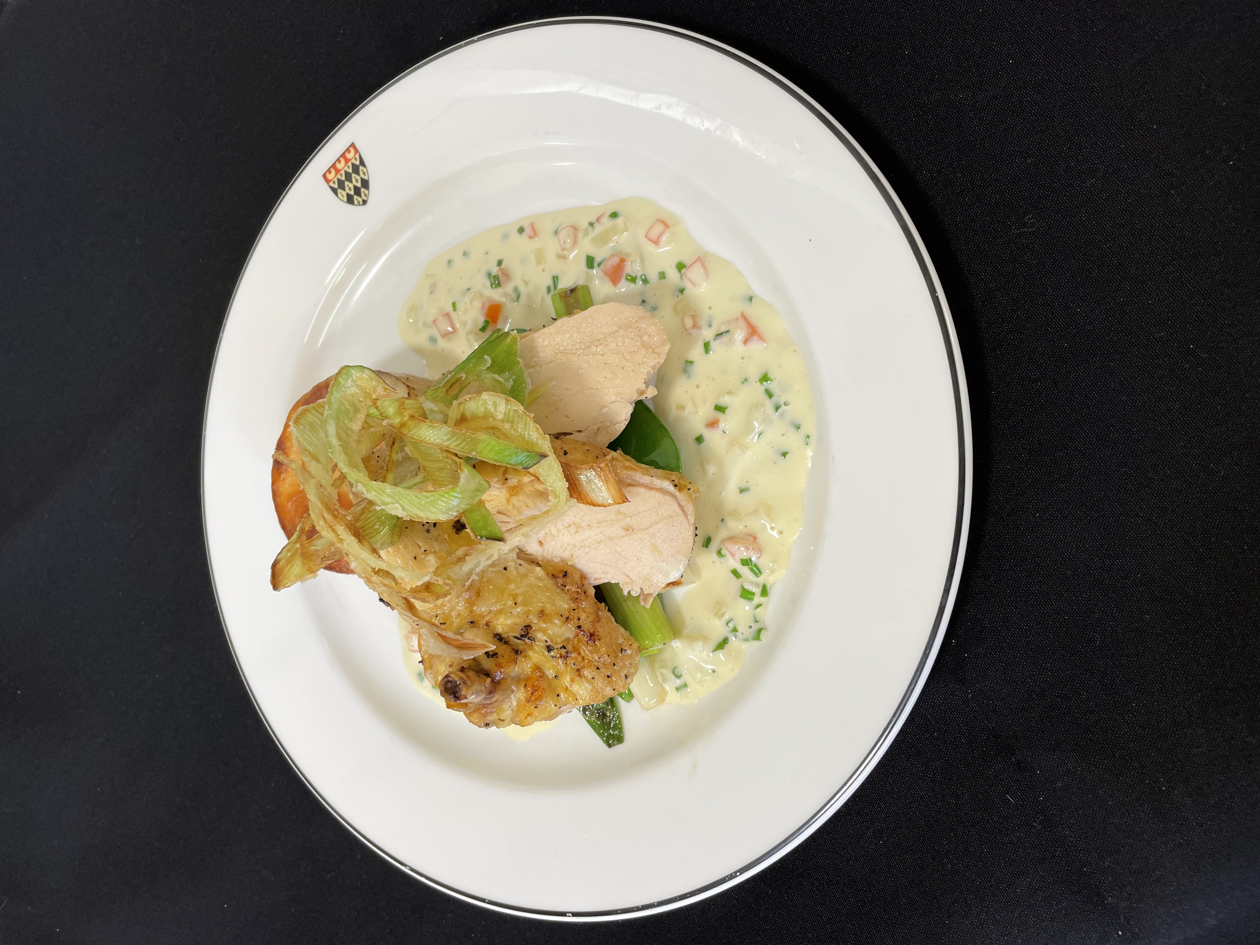 Pan fried corn fed chicken served with a white wine butter sauce and baby vegetables