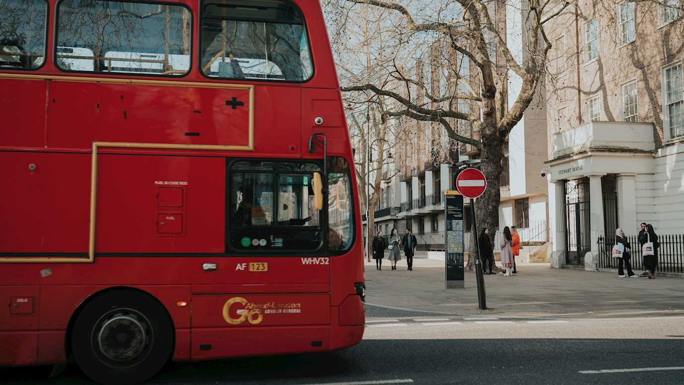 London bus by Stewart House, part of Royal Holloway in London.