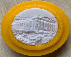 A yellow circular object with a white circle in it
Description automatically generated
