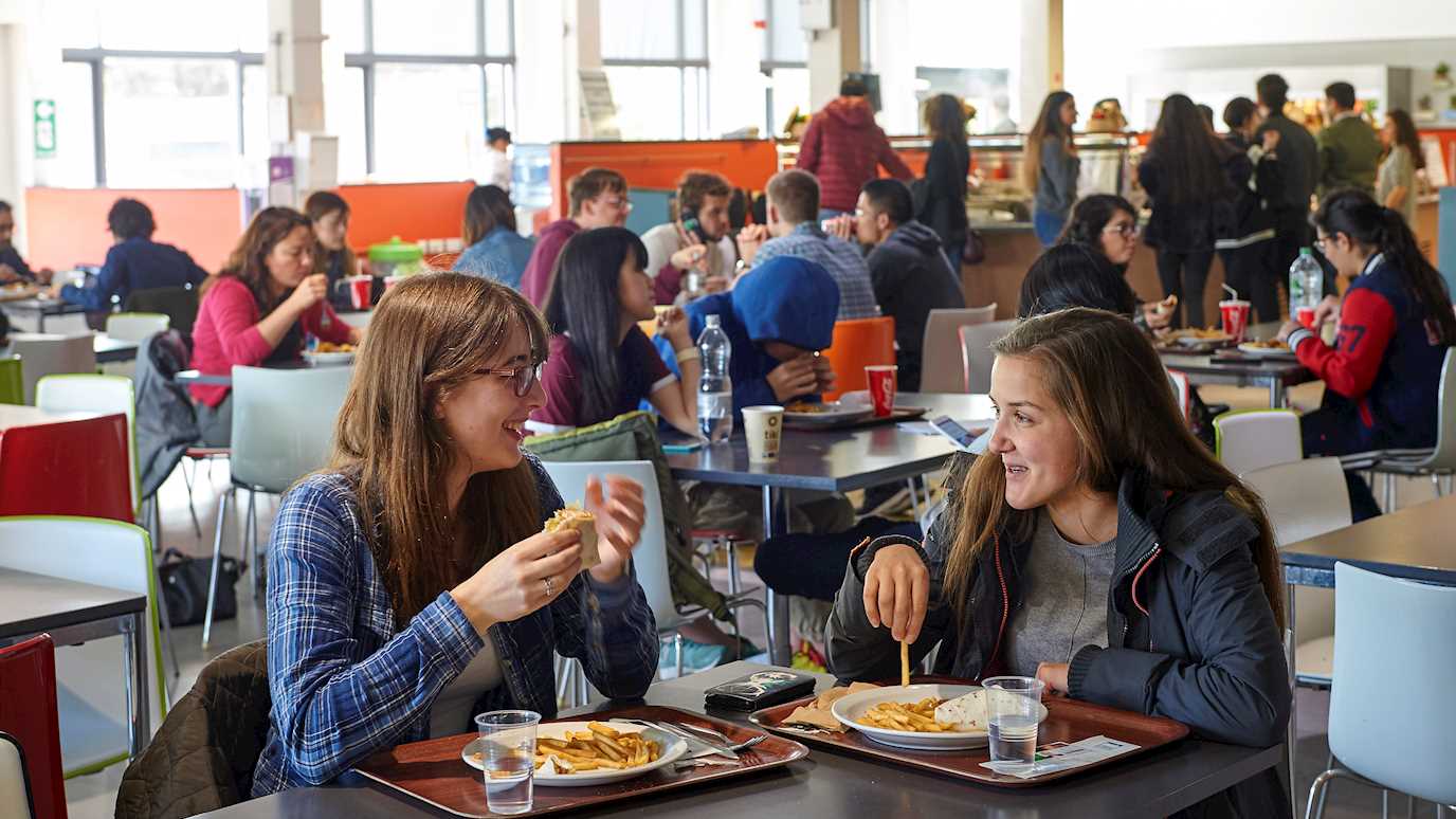 Students chatting over lunch in the Hub - Our campus the hub