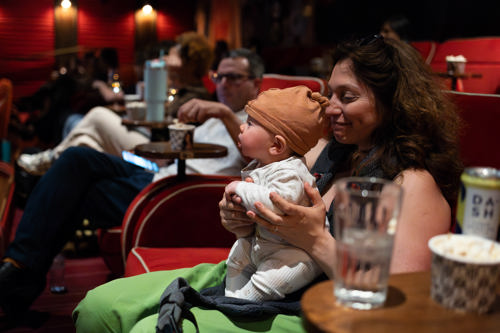 A mother and child at a screening of Motherboard.